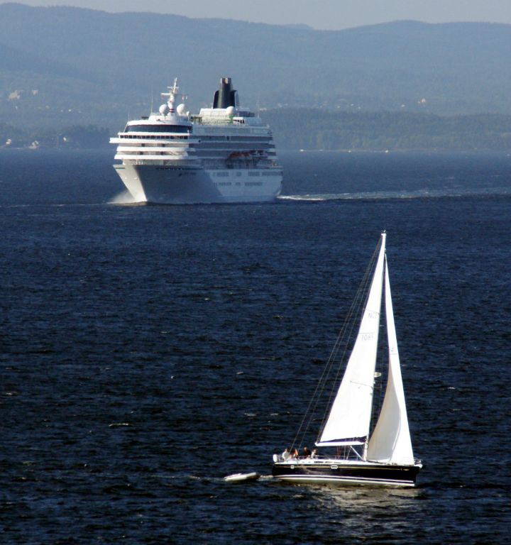 The Crystal Symphony following Arcadia out of Oslo.