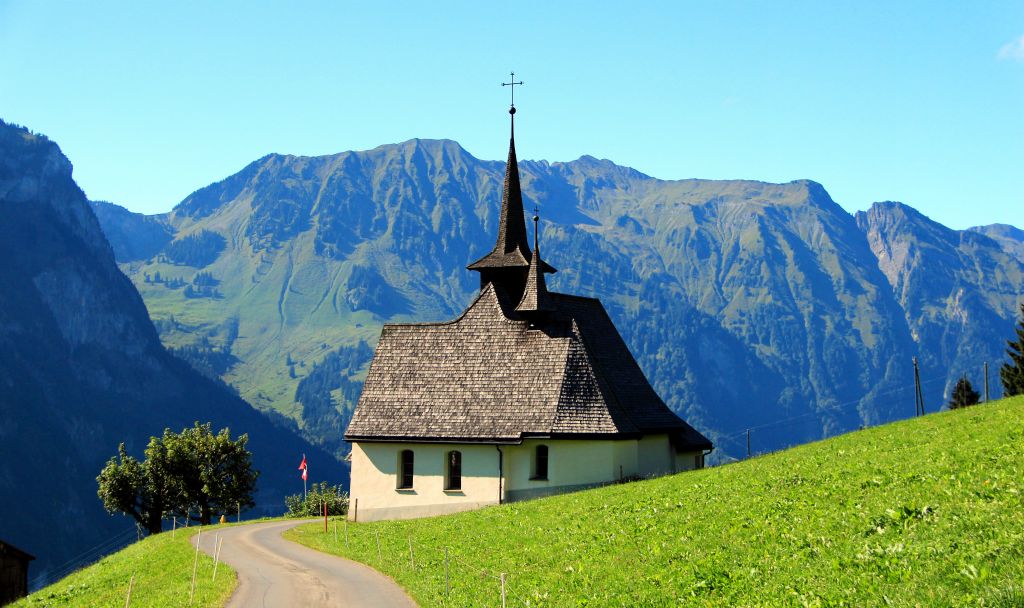 I thought this small church looked nice against the background of mountains.