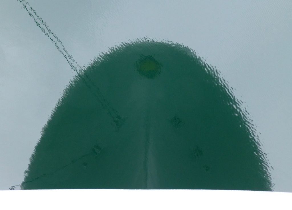 Before heading ashore, I took a few photos around the ship. I took this one at the front of the promenade deck by leaning over the front and pointing my camera straight down. So I’ve taken a photo of the bow of the ship reflected in the water.