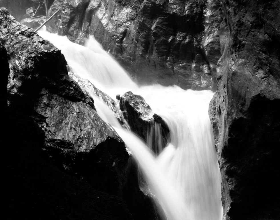 A waterfall in the gorge rendered in black and white. Although I had no ND10 filter, or even a polarising filter, it was dark enough in the gorge that an f/14 aperture at ISO100 was sufficient for a 1/3 second shutter, which blurred the water nicely.