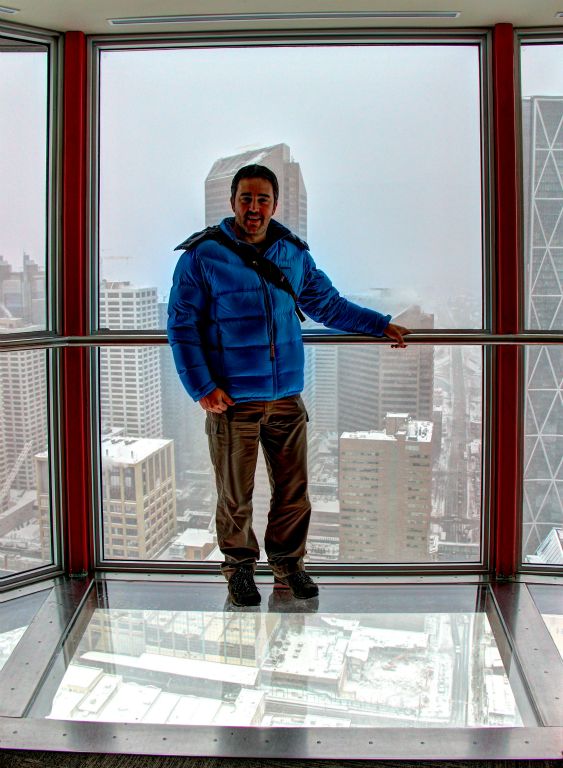 Me on the glass floor on the observation deck of the Calgary Tower (and holding on tightly to the rail, just in case).