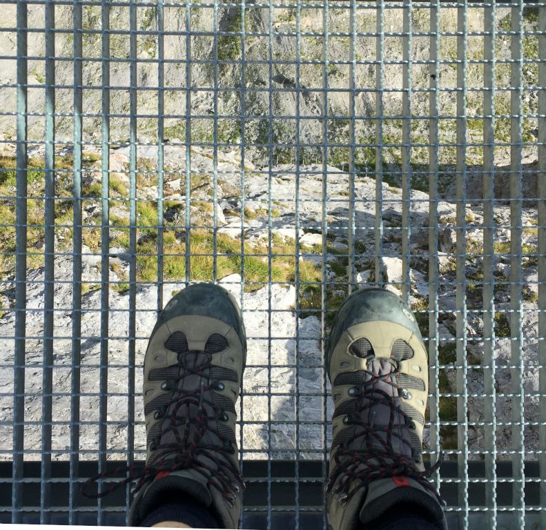The floor of the walkway is a robust metal mesh that offers an excellent view down. If you were unlucky enough to fall off I don't think you'd hit anything solid for at least a thousand feet!