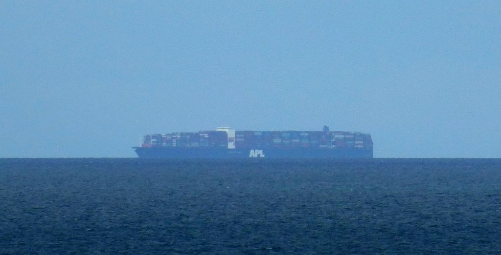 As we were leaving port I could see what looked like a large island on the horizon. However, on full zoom it's just possible to make out that it's one of those enormous container ships. I would have liked a closer look at that, but it appeared that we were moving in opposite directions.Later in the crossing, not far out of Portsmouth, we passed quite close by a cruise ship, but it was fully dark by then so I couldn't make out any details.