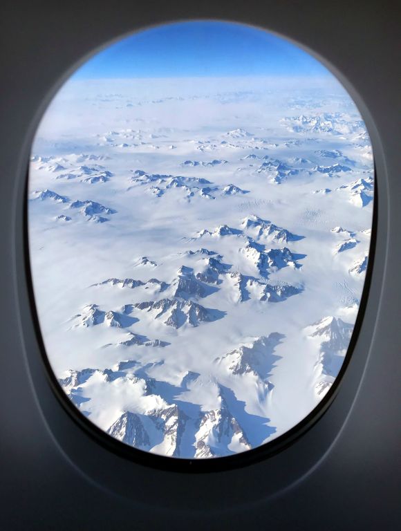 The view flying over Greenland.When the fellow came to take my order for (the six course) dinner he asked "And will you be dining with Mrs Sissons?", to which I replied "Er? Is that a thing you can do in First Class?" Apparently it is. First Class pods have a guest seating area and a fold out dining table larger than some of the tables for two I've had in ground-based restaurants.
