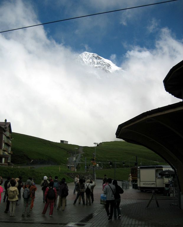 At Kleine-Scheidegg there are supposed to be amazing views of the Eiger, Monch and Jungfrau mountains. Unfortunately it was almost completely overcast while we were there. We did get this very brief glimpse of one of them (not sure which one though). Notice that all of the people have turned to look.