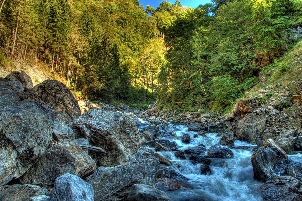 At the lowest point of the trail (about 800m), I reached the bottom of the valley. This is where the river running through town ends up.Due to the inconvenient position of the sun, the foreground was in deep shade, whilst the trees in the background were in full sun. So I took this HDR shot to try to balance out the exposure a bit. It's not a bad effort, but it looks like I could have gone an extra stop or so with the bracketing.