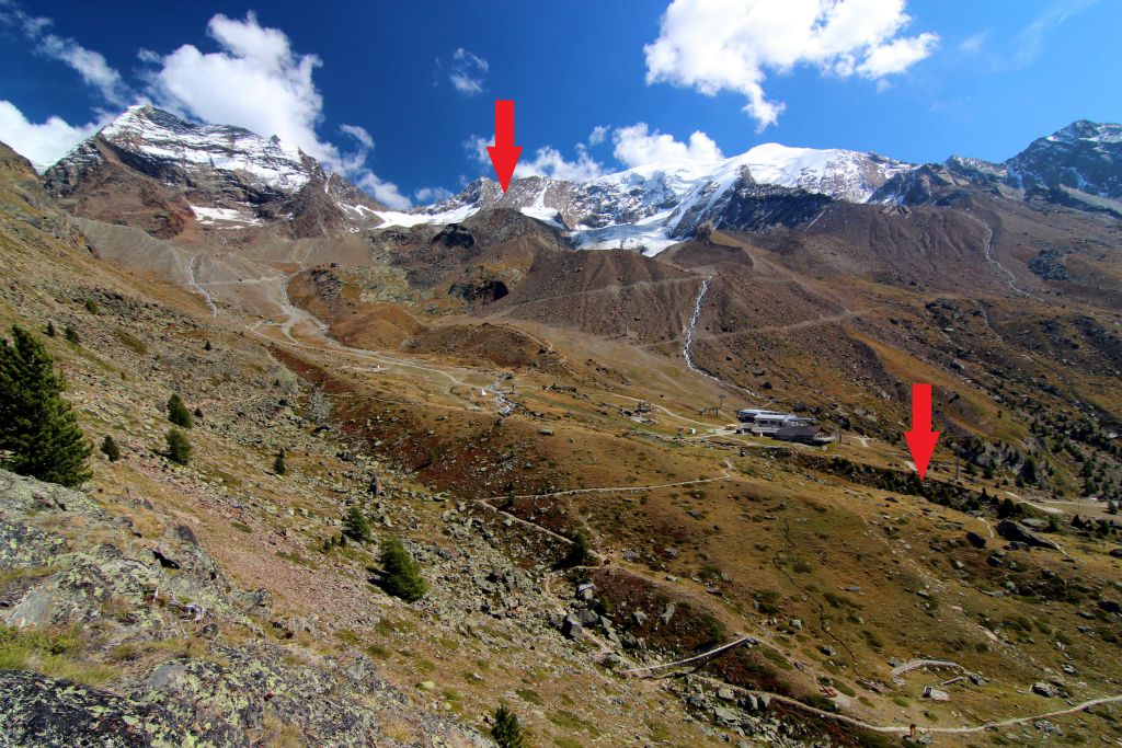 The view point, as its name suggests, offers a good view of the area. The arrow on the left is pointing to the top station, Hohsaas, were we’ll be heading once the cablecars start up again. The arrow on the right shows were Judith is sitting on the hammock reading her book. The cablecar station we’re “stuck” at is visible between the two.