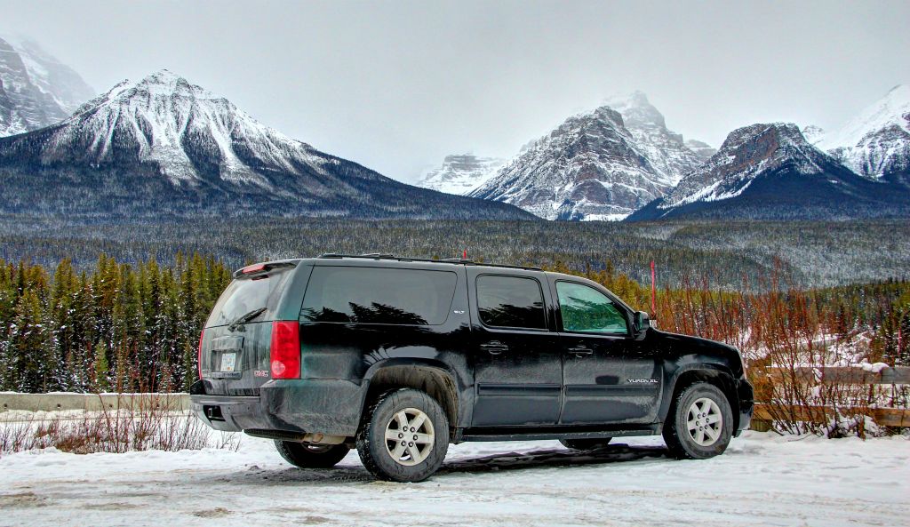 A photo of our Yukon with the mountains surrounding Lake Louise in the background.