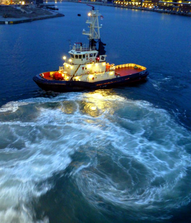 Tuesday - We arrived in Copenhagen just before dawn and were followed into port by this tug. The big whirl of turbulent water is from Arcadia's azipods (they're what Arcadia uses instead of propellers and a rudder) as they started to turn the ship around.