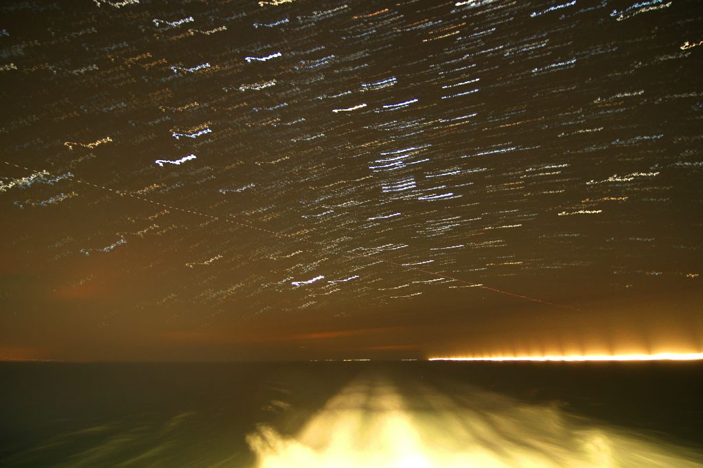 Once we were out at sea, I thought I'd have a crack at doing a star trails photo. Turned out that they don't work very well from a moving ship. Not that surprising really when you think about it. No idea what that glow on the right side of the horizon was.