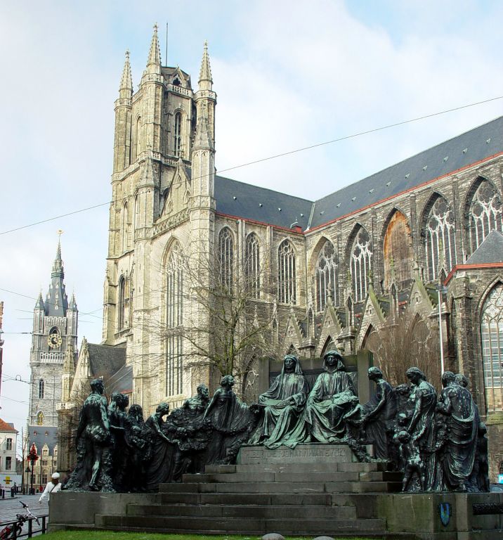 Monument showing Hubert and Jan van Eyck being greeted by the citizens of Ghent. St Baafskathedraal in the background. Belfort in the distance.