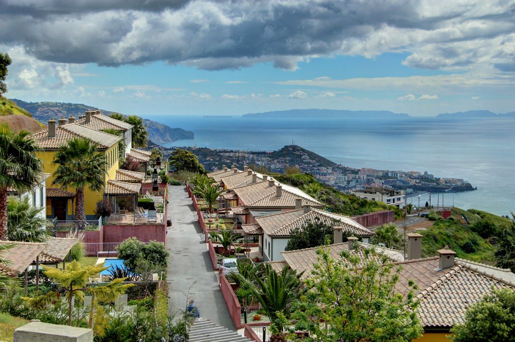 We picked up our hire car and drove the 15 miles or so to the Holiday Property Bond resort at Cabo Girao. Here's a view down the "street" that our villa was on. Our villa is the yellow one on the left of the photo. Funchal is visible in the distance. Despite being pretty much right on the coast, the resort is around 500m (about 1,640 feet) above sea level.
