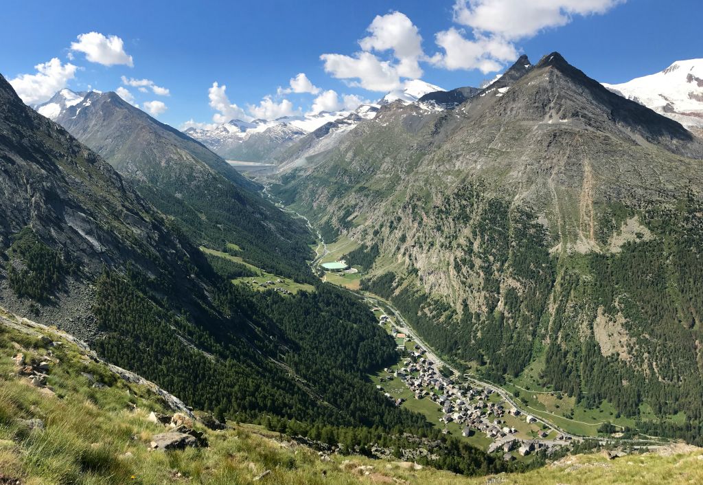 Saas Almagell is visible in the valley, with the Mattmark dam and reservoir just visible in the distance.