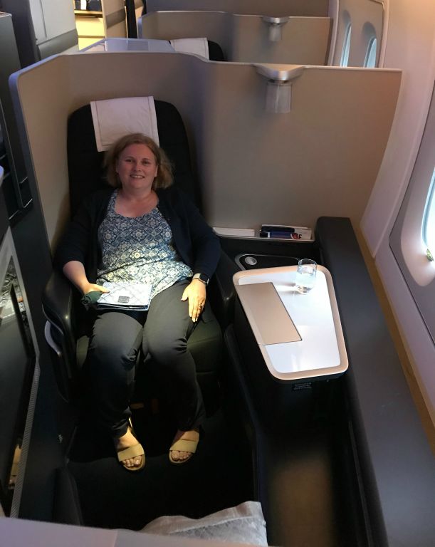 Here's Judith in her pod, making the most of what will likely be our last flight in First Class :o(