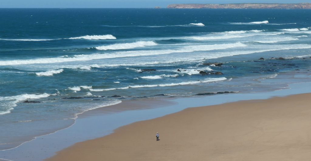 ...to the magnificent beach of Praia da Cordoama, which was almost as windy as it was deserted. Judith is just visible in the foreground.