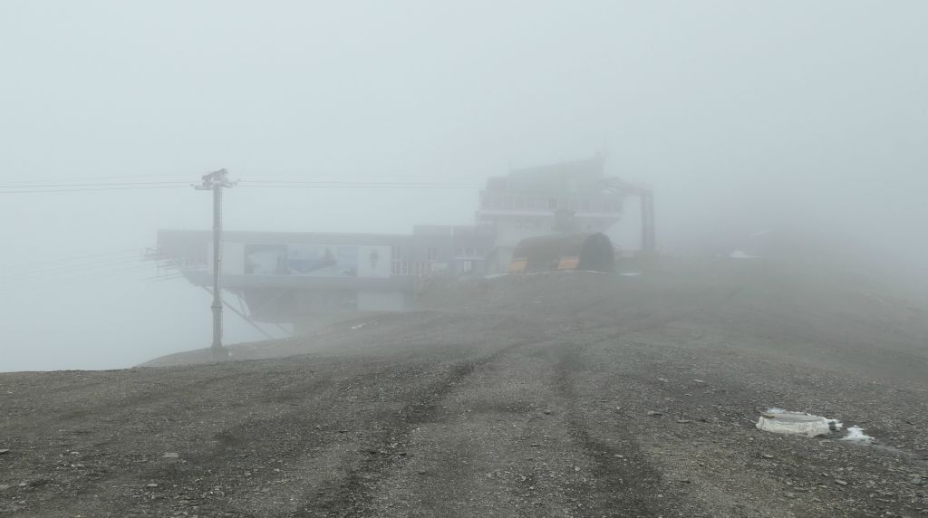 Finally the cablecar station at Plaine Morte came into view through the clouds. I was glad to have been following a GPS trail on my watch because there was no discernable trail on the ground to follow and with the poor visibility it would have been easy to wander off in the wrong direction.